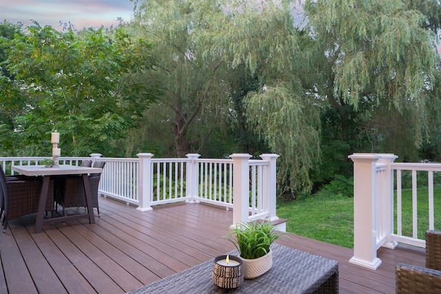 deck featuring a yard and outdoor dining area