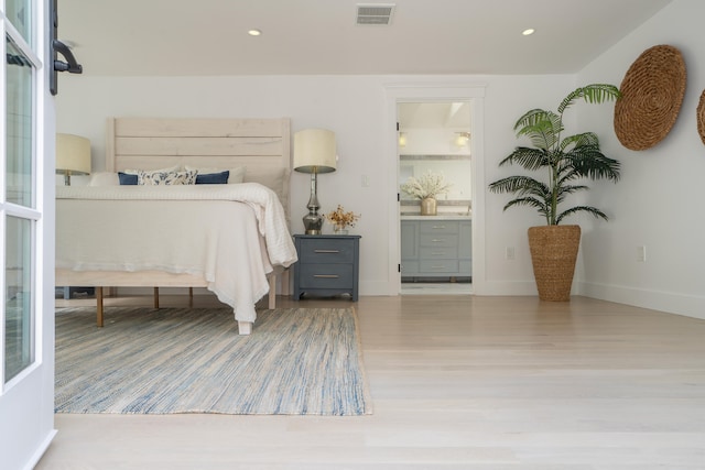 bedroom with recessed lighting, visible vents, connected bathroom, wood finished floors, and baseboards