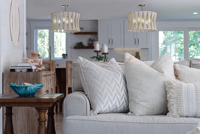 living room with ornamental molding and wood finished floors