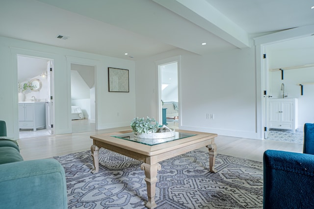 living area with light wood-style floors, baseboards, visible vents, and recessed lighting