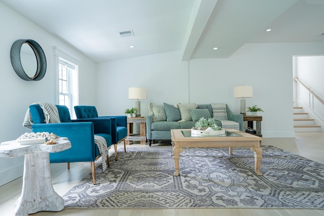 living room featuring recessed lighting, wood finished floors, visible vents, and stairs