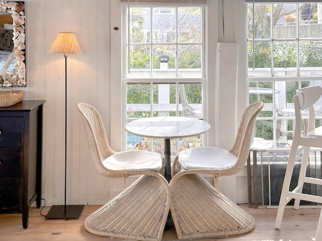 dining room featuring wood walls and hardwood / wood-style floors