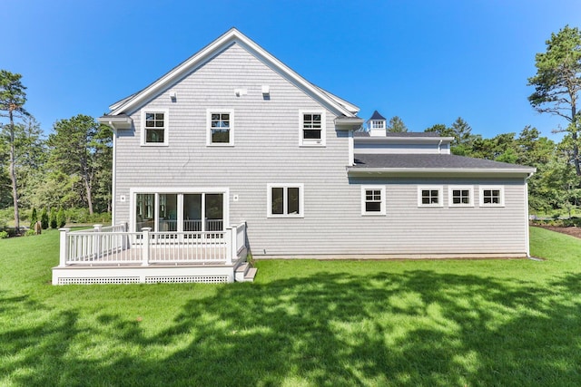 back of house with a wooden deck and a yard