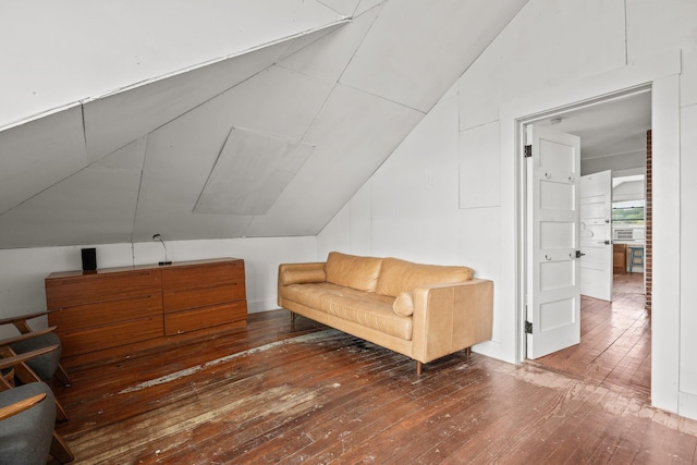 living area featuring vaulted ceiling and hardwood / wood-style floors