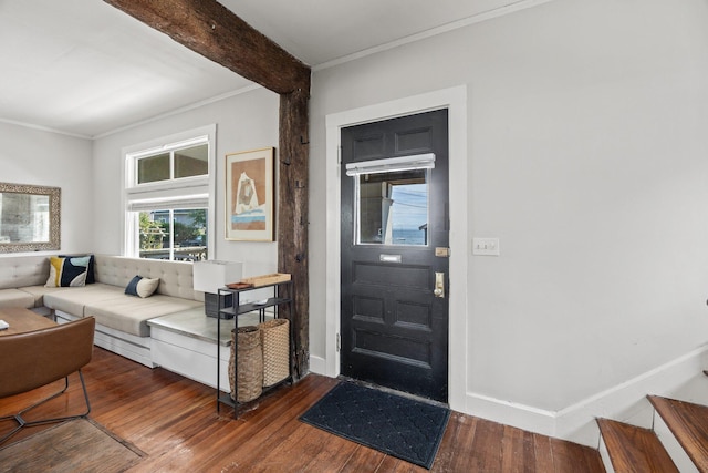 entryway with beam ceiling, crown molding, and dark hardwood / wood-style floors