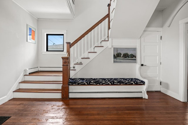 stairs featuring baseboard heating, hardwood / wood-style floors, and ornamental molding