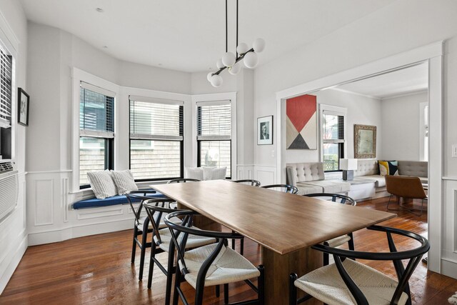 dining area featuring a notable chandelier and dark wood-type flooring