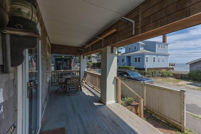 wooden deck with a water view and area for grilling