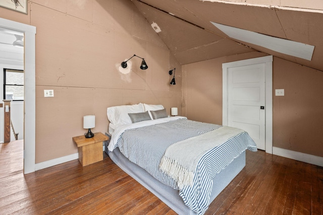 bedroom with dark hardwood / wood-style floors and lofted ceiling