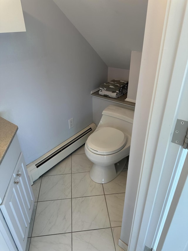 bathroom with marble finish floor, vanity, toilet, and a baseboard heating unit
