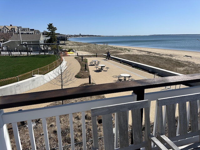 property view of water with fence and a view of the beach