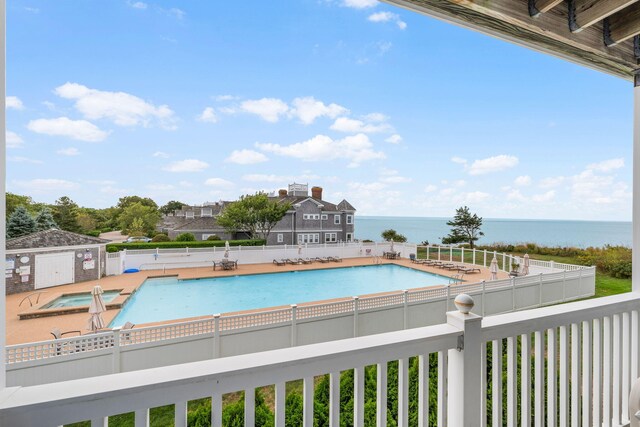 view of swimming pool featuring a water view