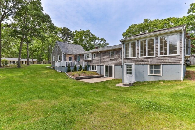 6 Januit St, Sandwich, MA 02563 - rear view of house with a lawn, a deck, and a patio
