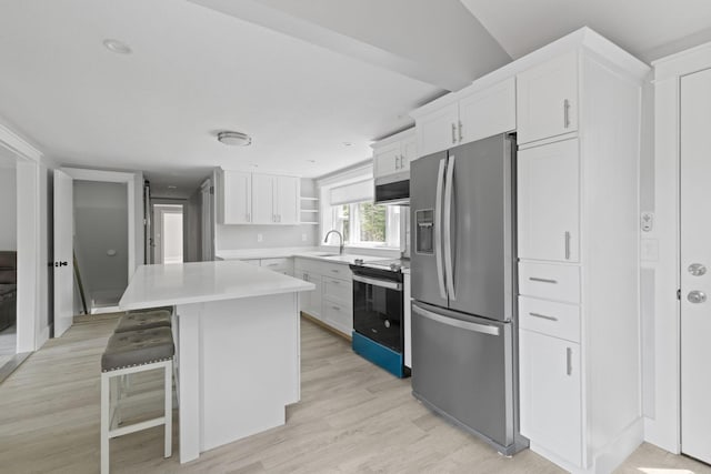6 Januit St, Sandwich, MA 02563 - kitchen with stainless steel appliances, a sink, white cabinetry, and light countertops
