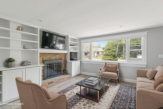 6 Januit St, Sandwich, MA 02563 - living room featuring a fireplace, baseboards, light wood finished floors, built in shelves, and recessed lighting