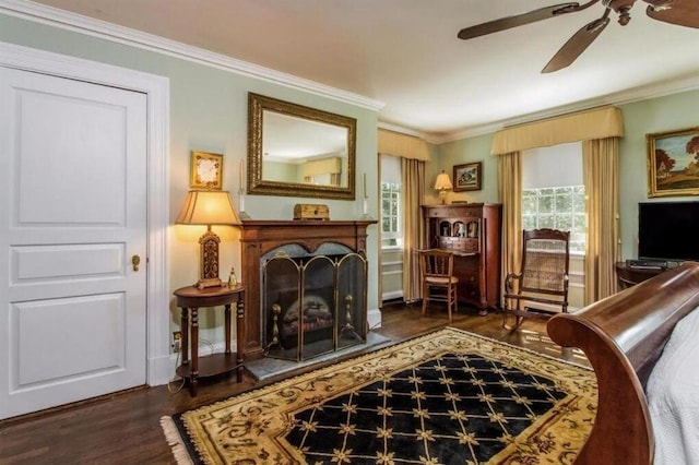 living area featuring ceiling fan, crown molding, and dark hardwood / wood-style floors