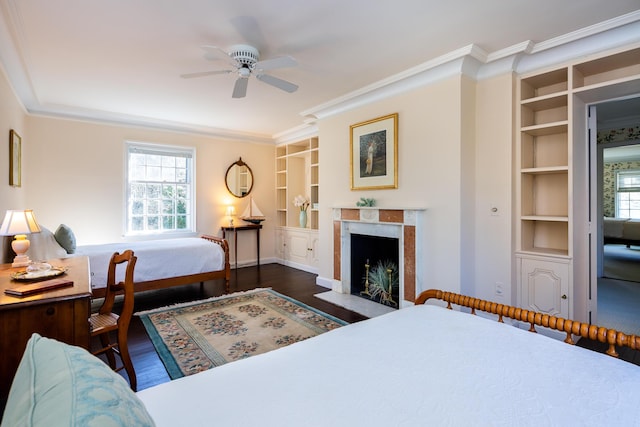 bedroom with dark wood-type flooring, ceiling fan, and ornamental molding