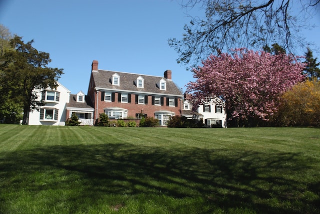 colonial-style house with a front yard