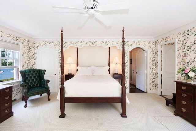 bedroom featuring crown molding, light colored carpet, and ceiling fan