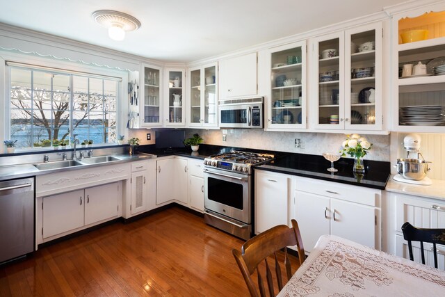 kitchen with decorative backsplash, sink, white cabinets, and appliances with stainless steel finishes