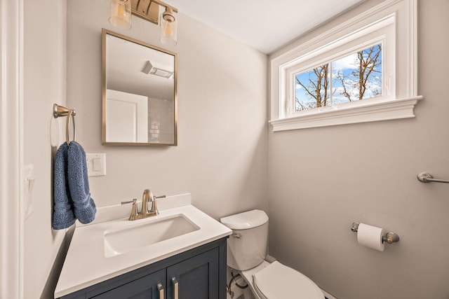 bathroom featuring toilet and vanity