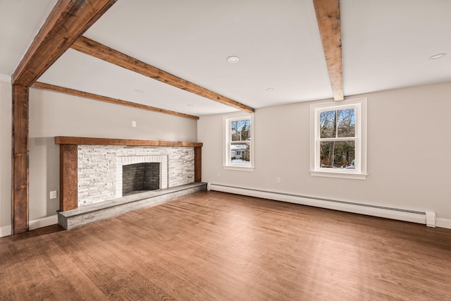 unfurnished living room featuring a stone fireplace, hardwood / wood-style floors, lofted ceiling with beams, and a baseboard heating unit