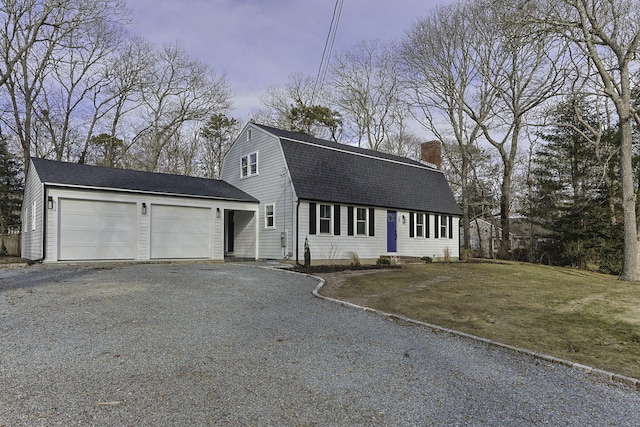 view of front facade with a garage and a yard