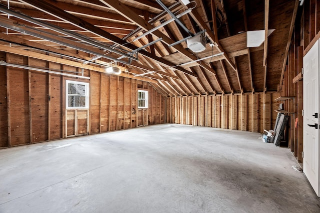 misc room featuring concrete flooring and vaulted ceiling