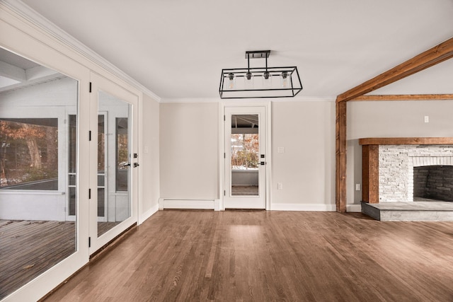 unfurnished living room with hardwood / wood-style flooring, baseboard heating, crown molding, and a fireplace