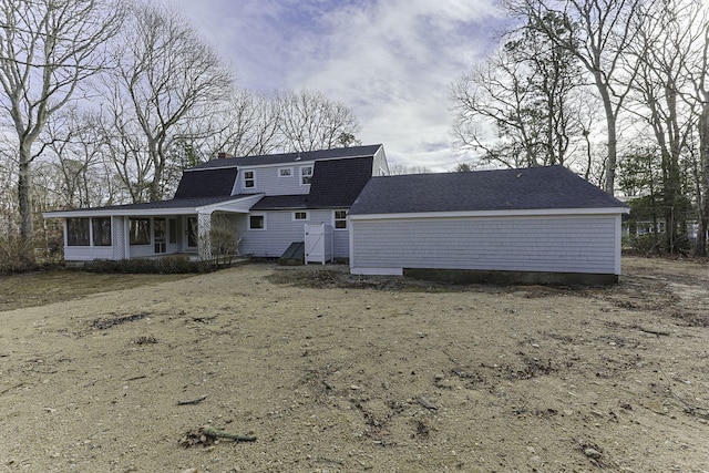 back of house featuring a sunroom