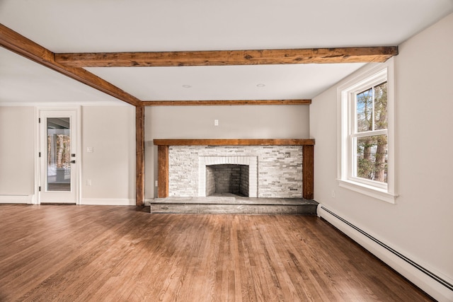 unfurnished living room with a fireplace, hardwood / wood-style floors, beam ceiling, and a baseboard heating unit