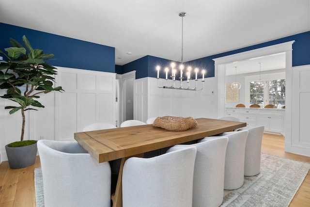 dining space featuring a chandelier and light hardwood / wood-style floors