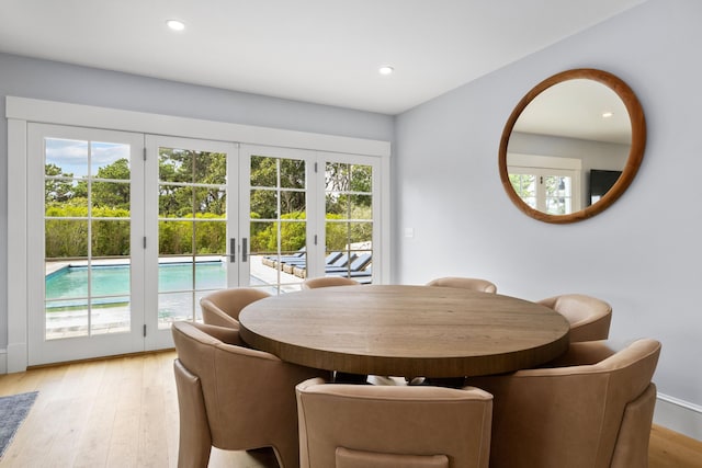 dining area featuring french doors, a healthy amount of sunlight, and light hardwood / wood-style floors