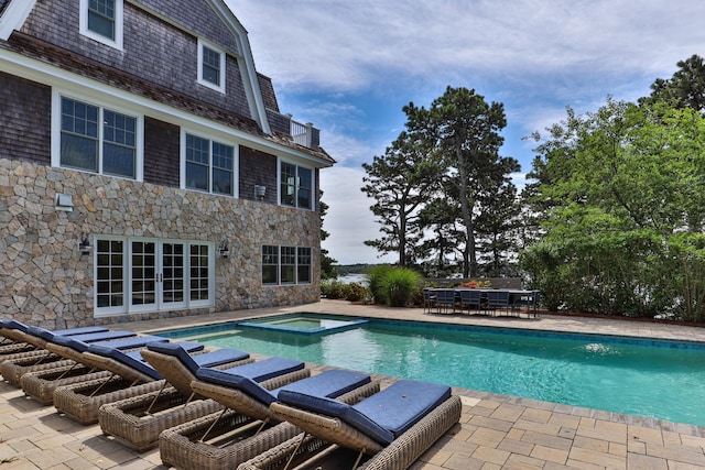 view of pool featuring an in ground hot tub and a patio