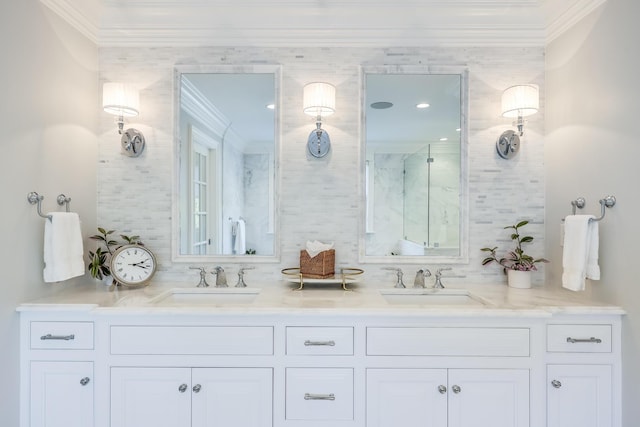 bathroom with a shower with shower door, vanity, and ornamental molding