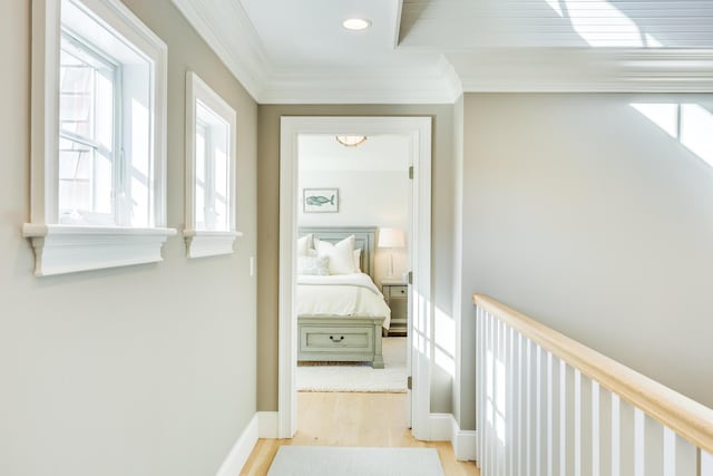 hallway featuring crown molding and light wood-type flooring