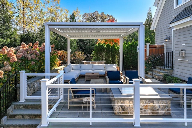 wooden deck featuring a pergola and an outdoor hangout area