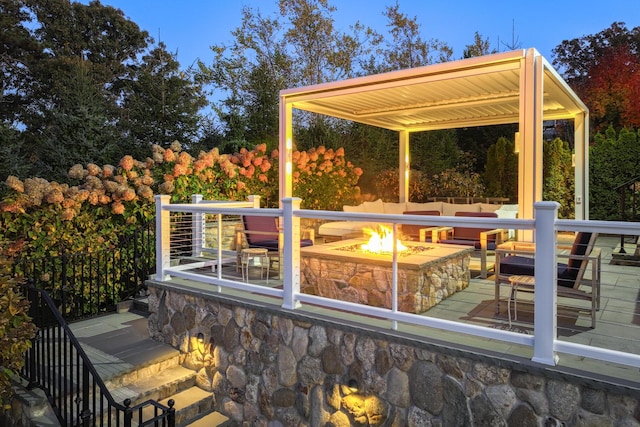 wooden terrace with a pergola and an outdoor living space with a fire pit