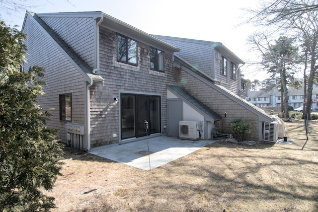 rear view of house featuring a patio, ac unit, a yard, and stairway