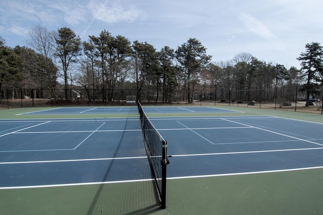 view of tennis court featuring fence