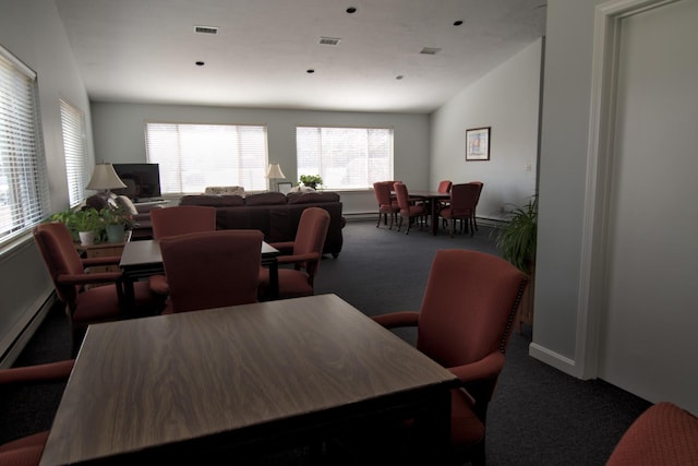 carpeted dining room featuring visible vents and baseboard heating