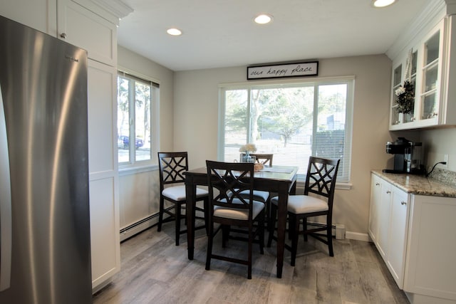 dining room featuring recessed lighting, light wood-type flooring, and baseboards