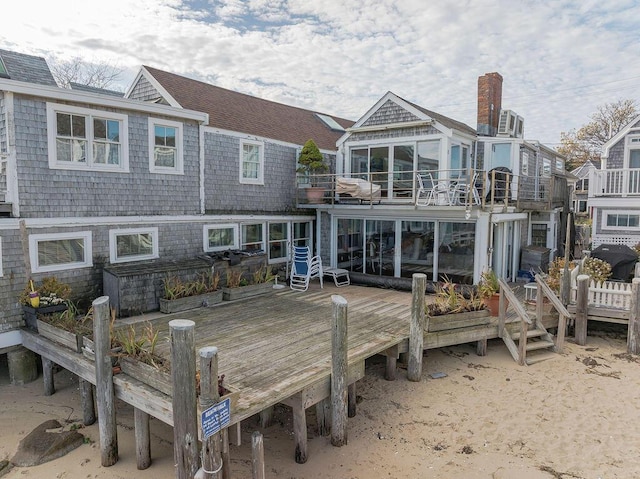 rear view of property featuring a wooden deck