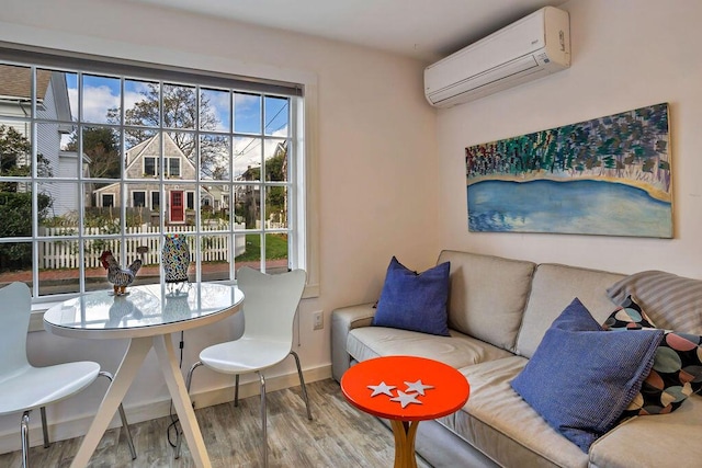 dining room with a wall mounted AC and hardwood / wood-style floors