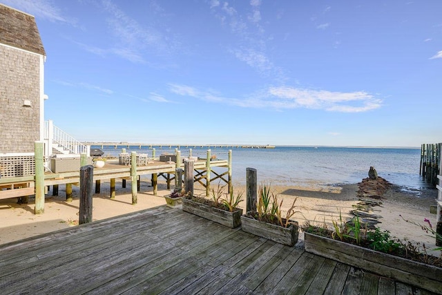 dock area featuring a water view and a view of the beach