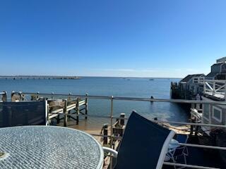 view of dock featuring a balcony and a water view