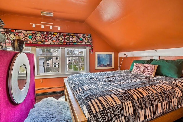 bedroom featuring vaulted ceiling and baseboard heating