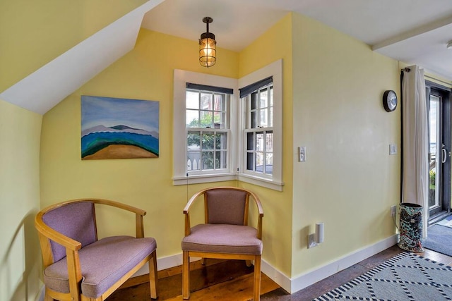 sitting room with lofted ceiling