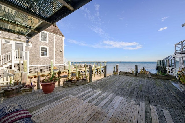 wooden terrace featuring a water view