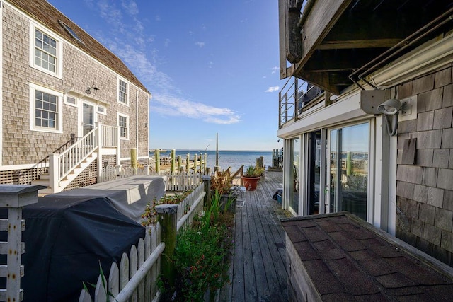 wooden deck featuring a water view and area for grilling